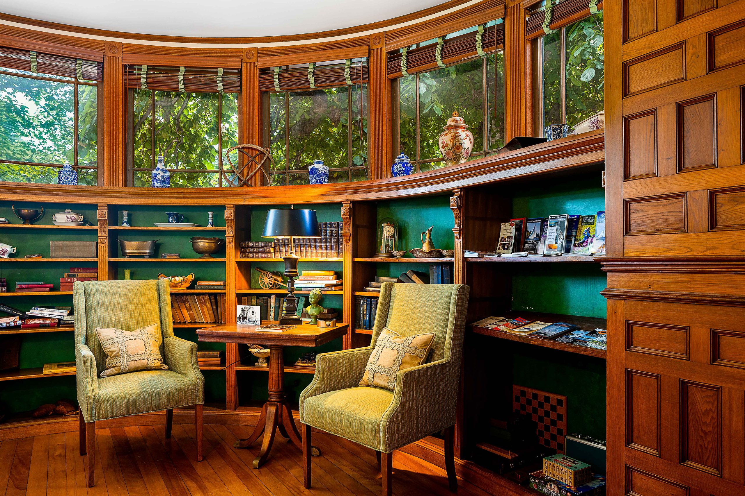 round room with wood walls and chairs