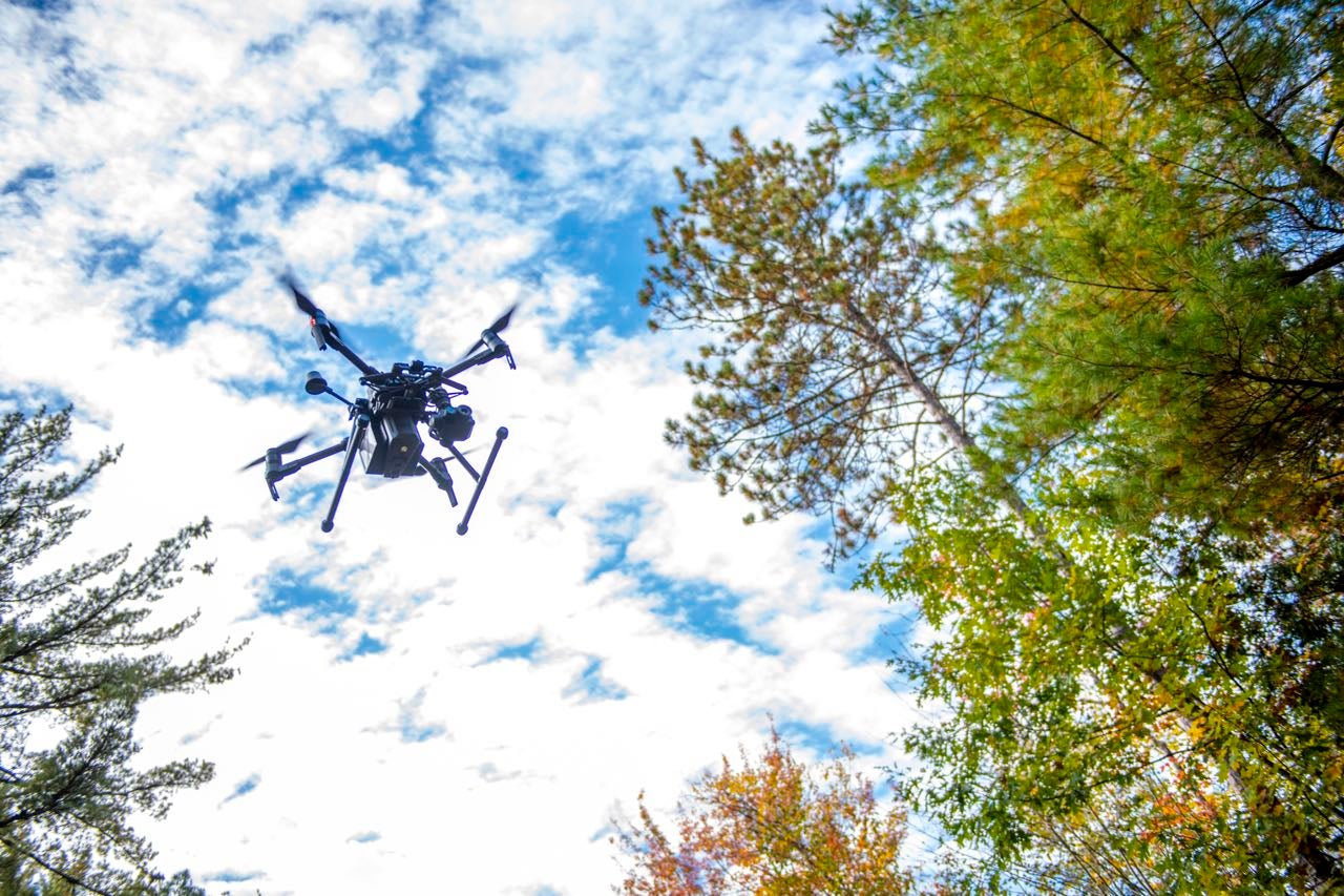 A drone is seen with the sky behind it.