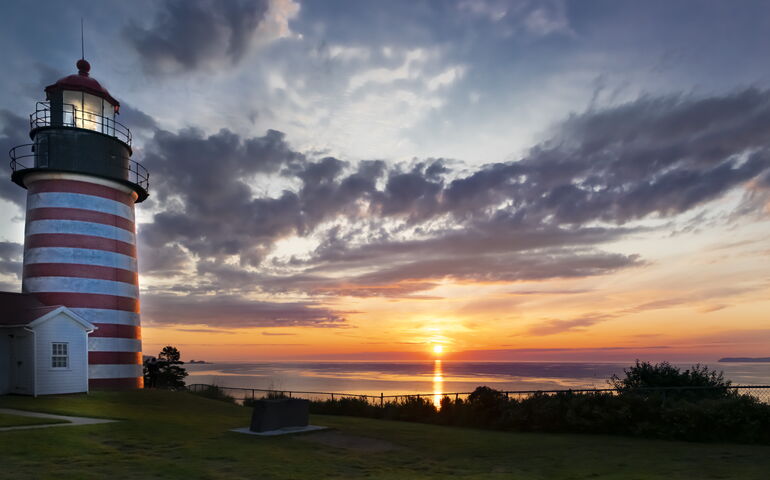 West Quoddy Head Lighthouse (red and white striped) at sunrise