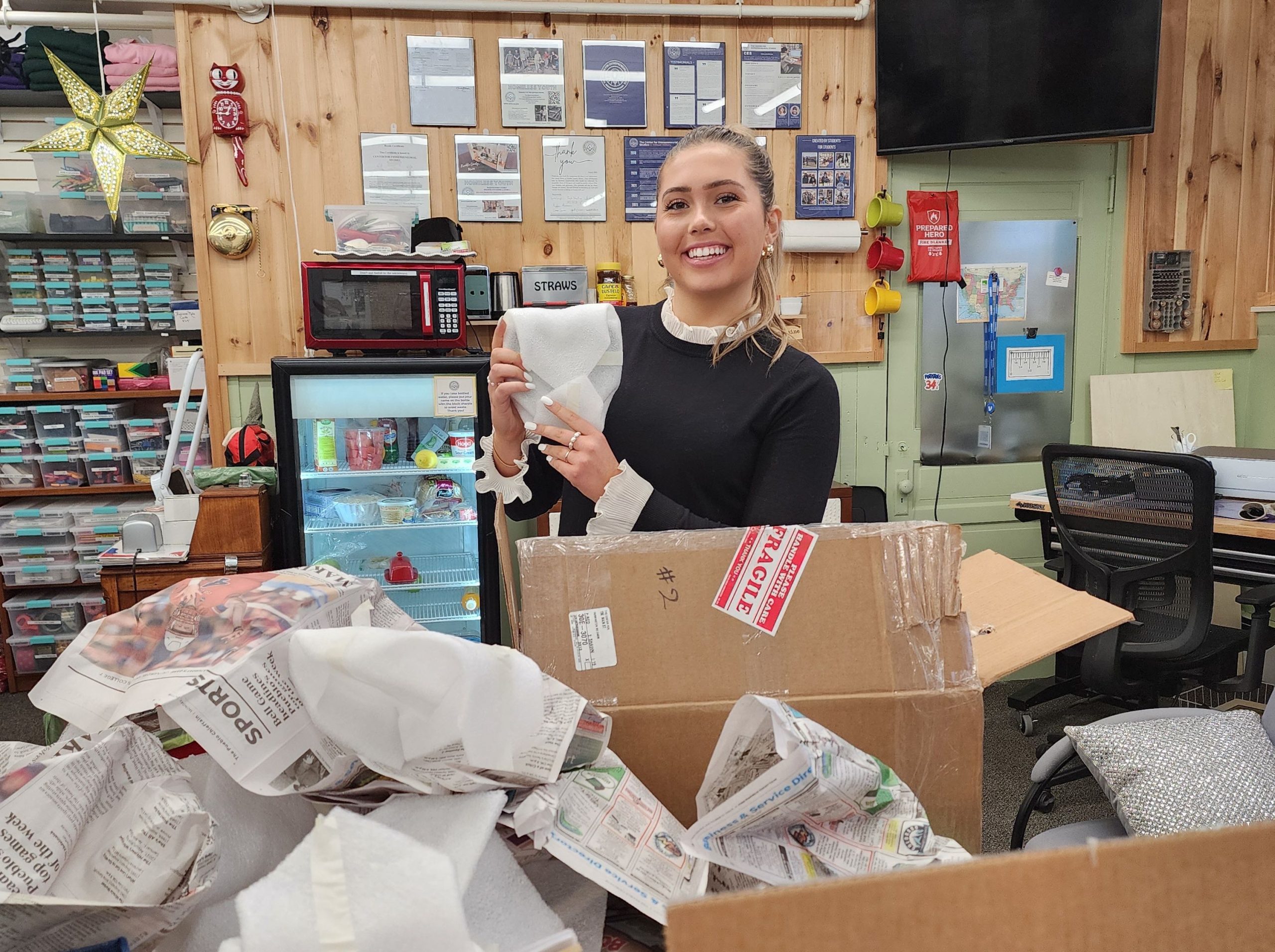 A person opens boxes with wholesale goods.