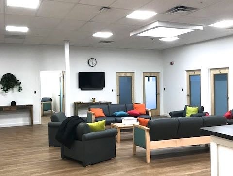 A room has chairs, a ccouch and a table.