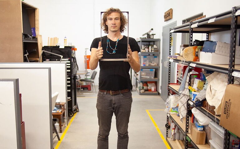 A person holds up a frame.