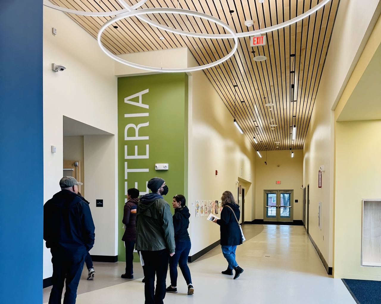 People gather in a hallway.