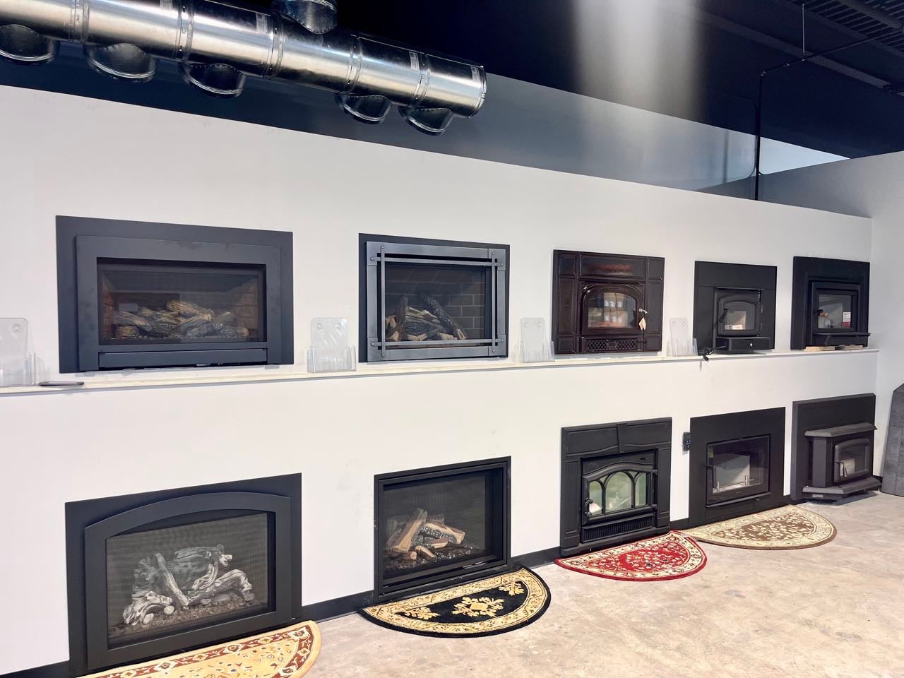 A wall has a number of metal-framed glass display.