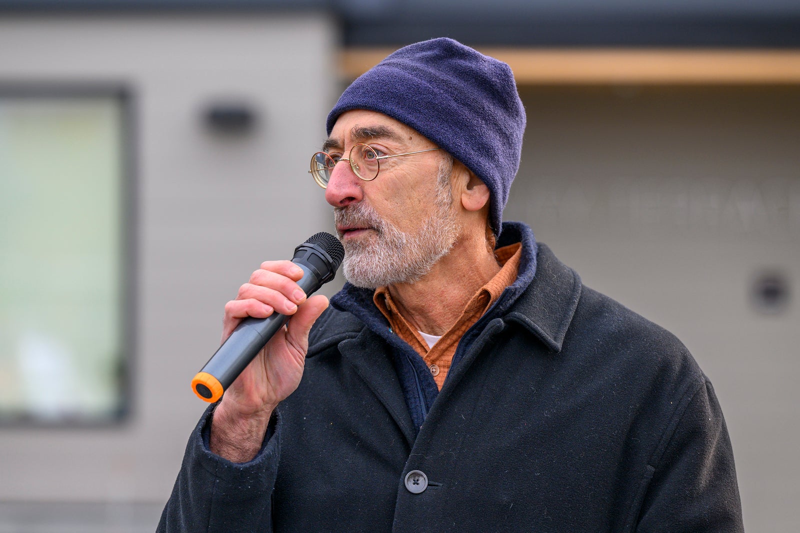 man speaks at microphone