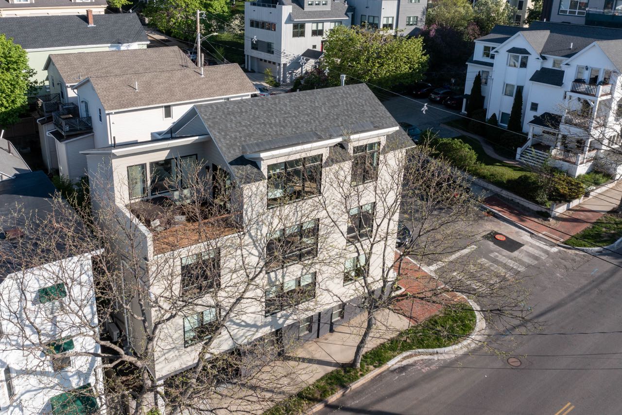 An aerial view shows a building with white siding.