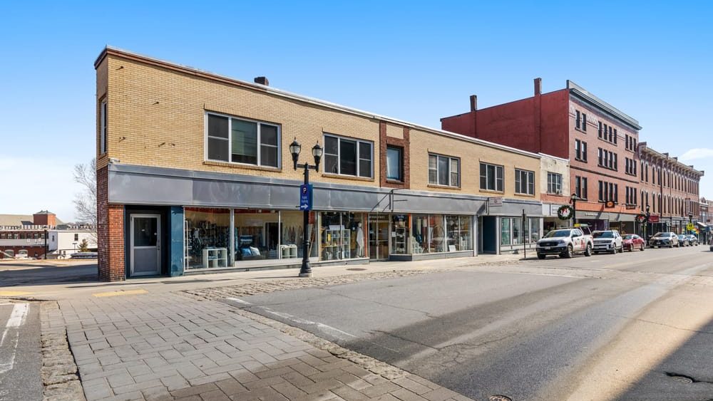 An exterior view shows a building and a street.