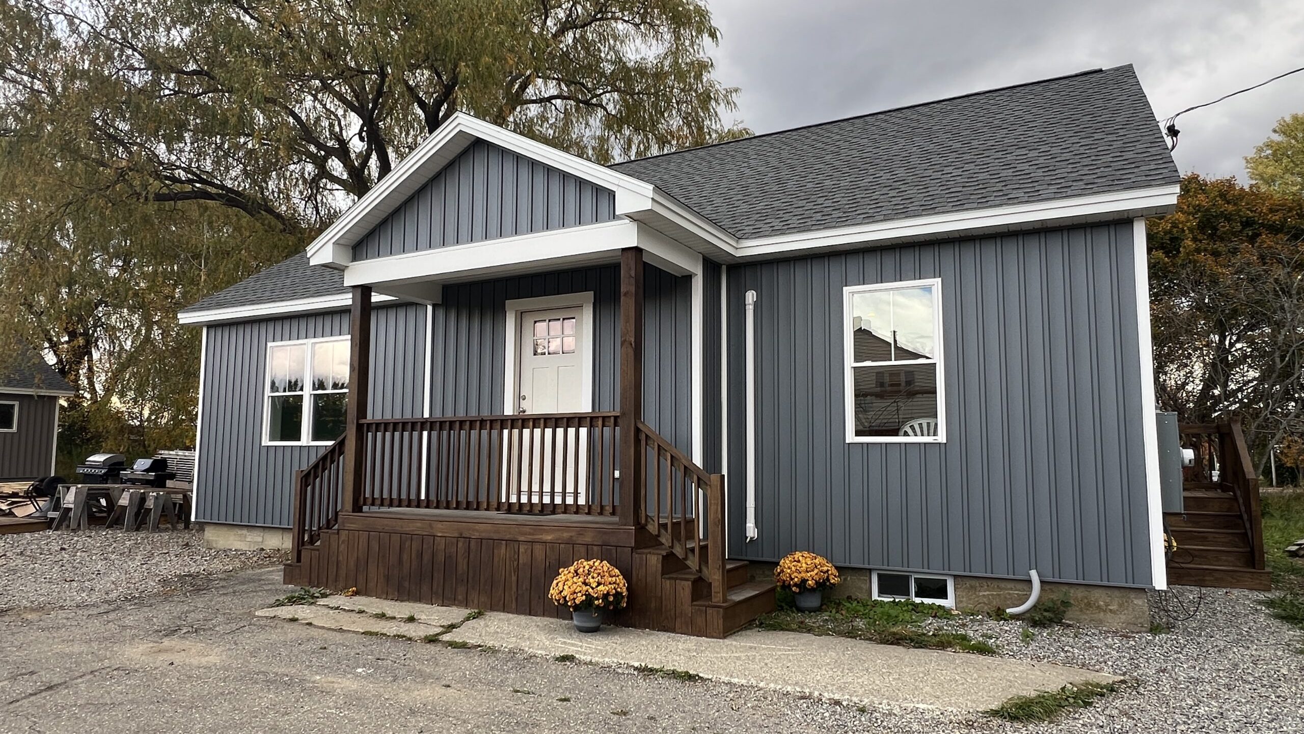 A small house has blue siding.