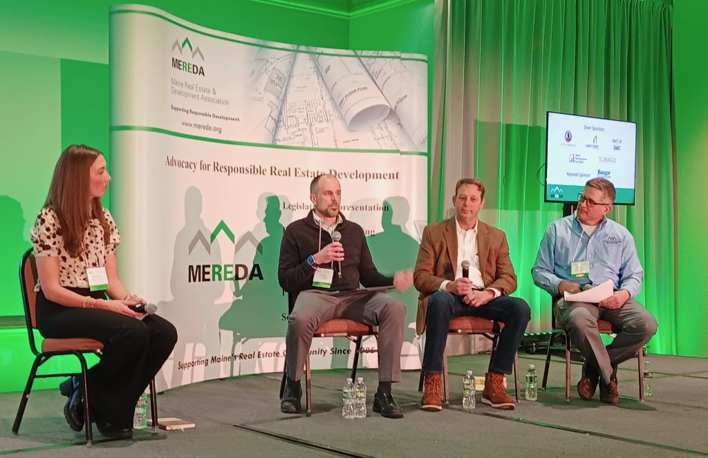 photo of four panelists on stage at MEREDA conference