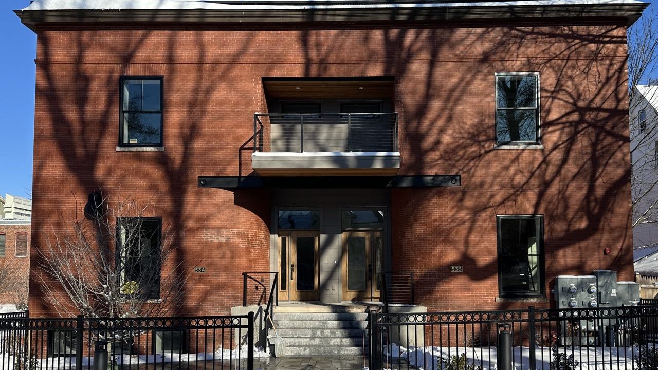A square building has a stoop.