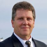 A person poses for a headshot.