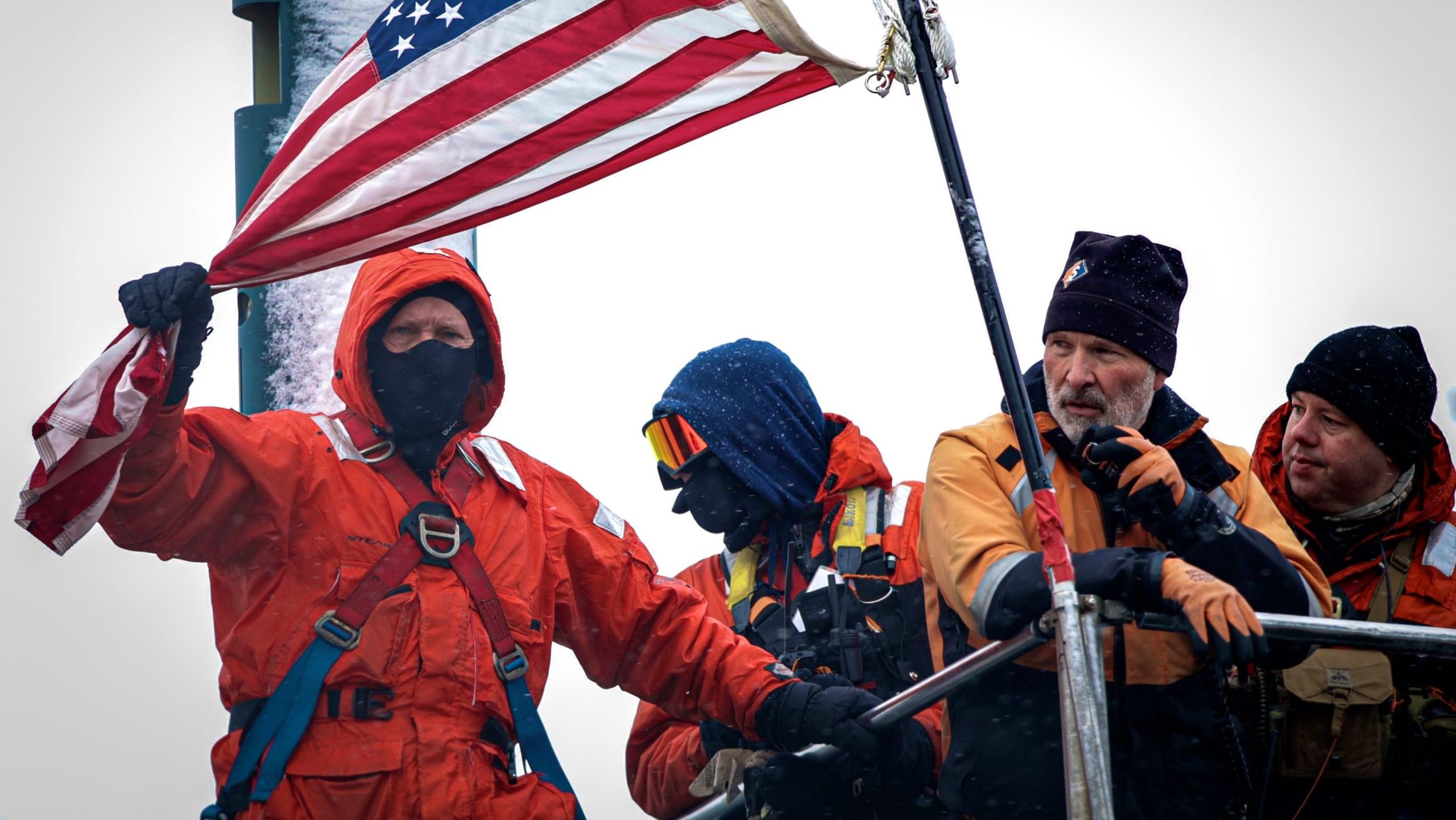 People are outside with a flag.