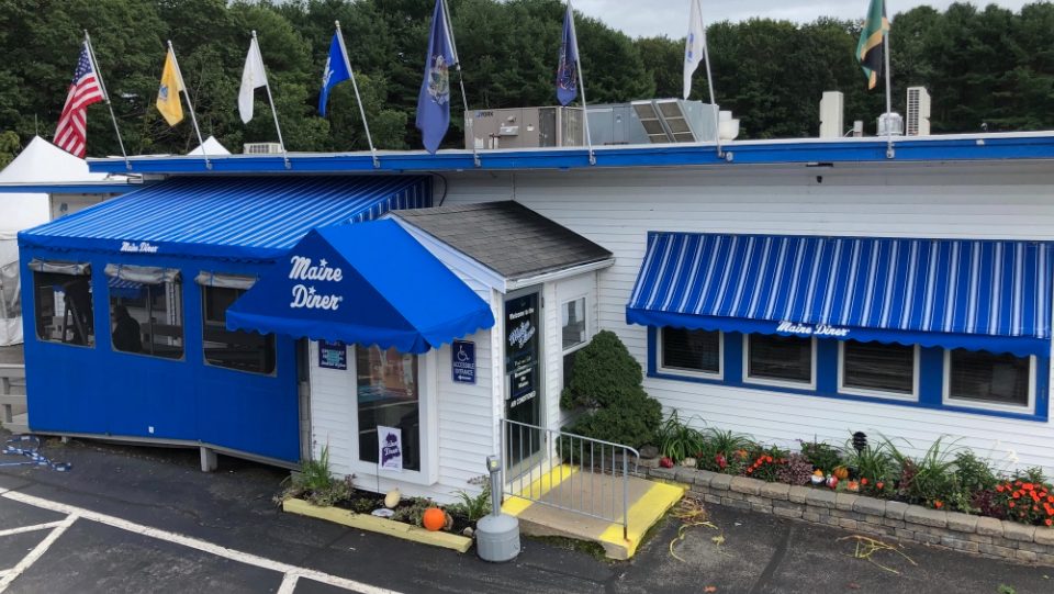 A building has a blue awning.