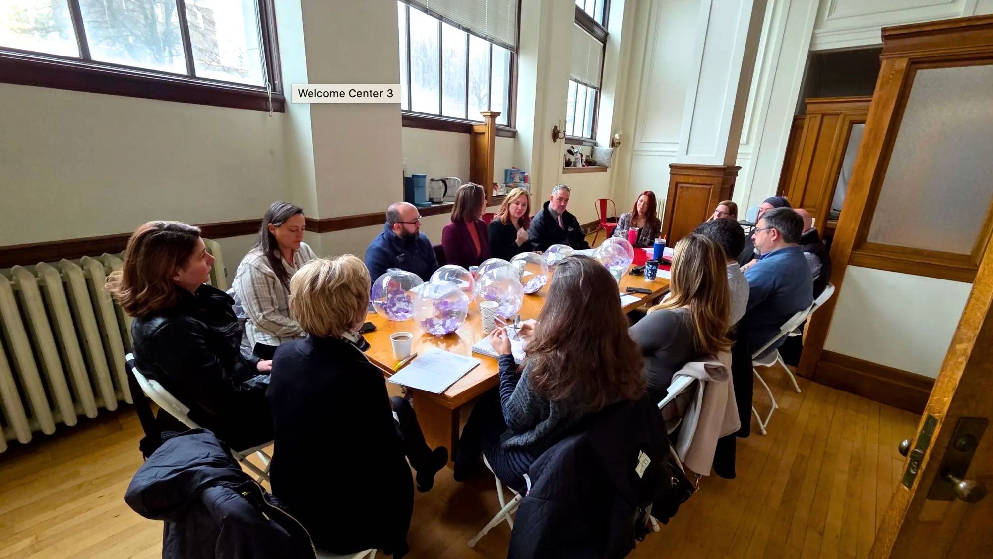 People sit at a long table.