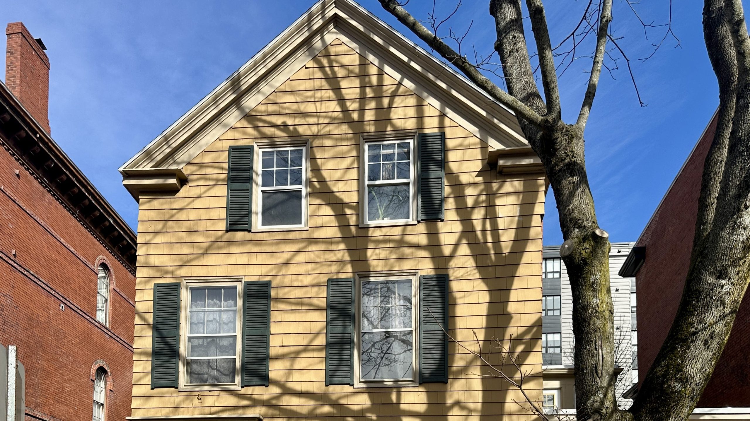 A house has yellow siding.
