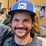 A person poses for a headshot.