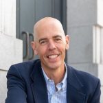 A person poses for a headshot.