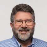 A person poses for a headdshot.