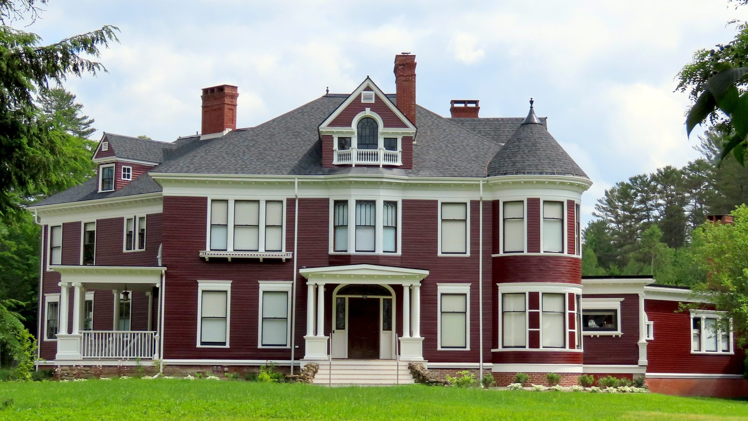 An old building has a green lawn.