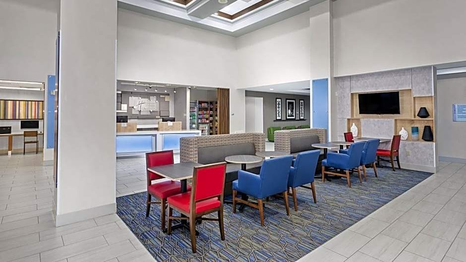 A room has a high ceiling and furnishings.