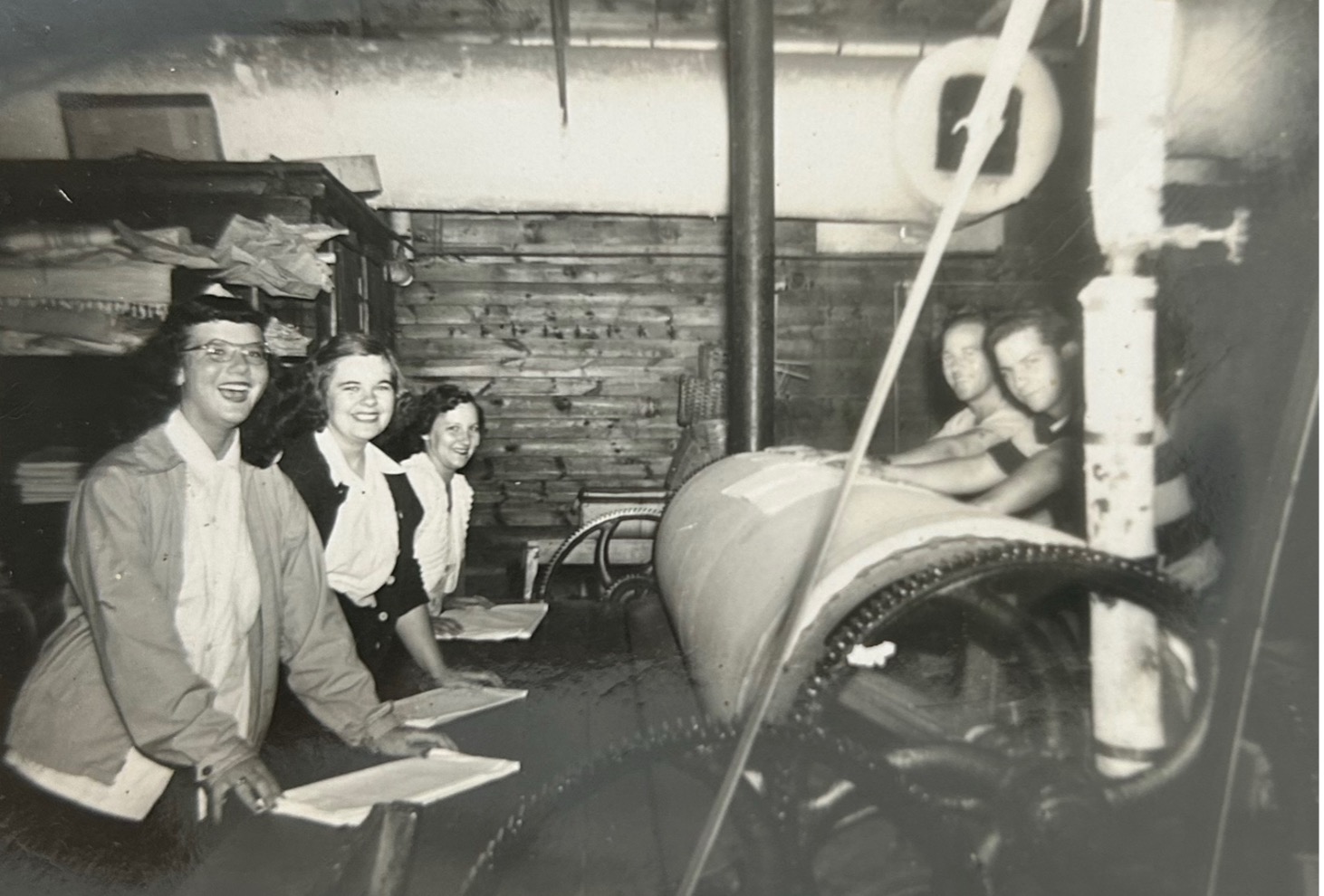 Vintage photo of women possibly passing linens.
