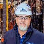 A person poses for a headshot.