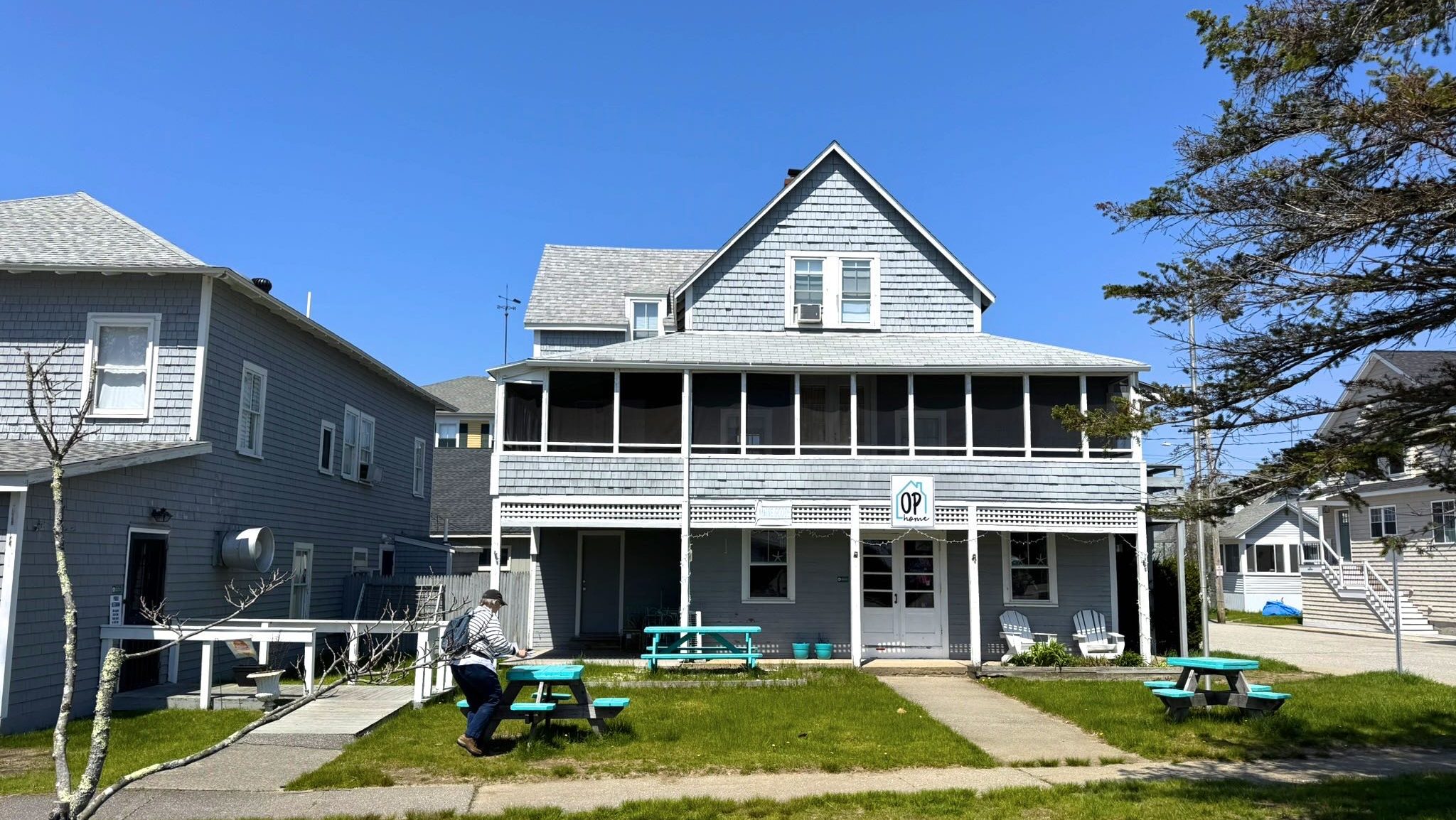 A building has a balcony and lawn.