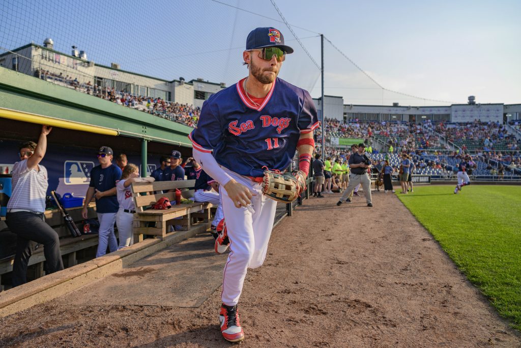 Portland Sea Dogs player coming off the bench and onto the field at Hadlock.