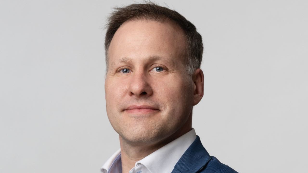 A person poses for a headshot.