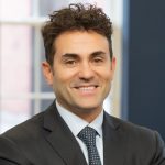 A person poses for a headshot.