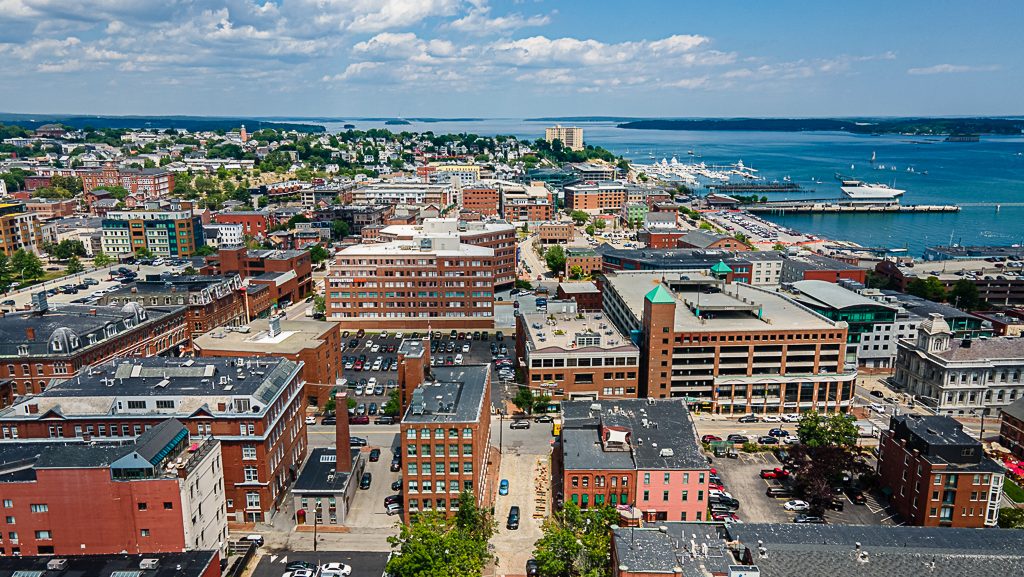 An aerial view of multiple buildings and water.