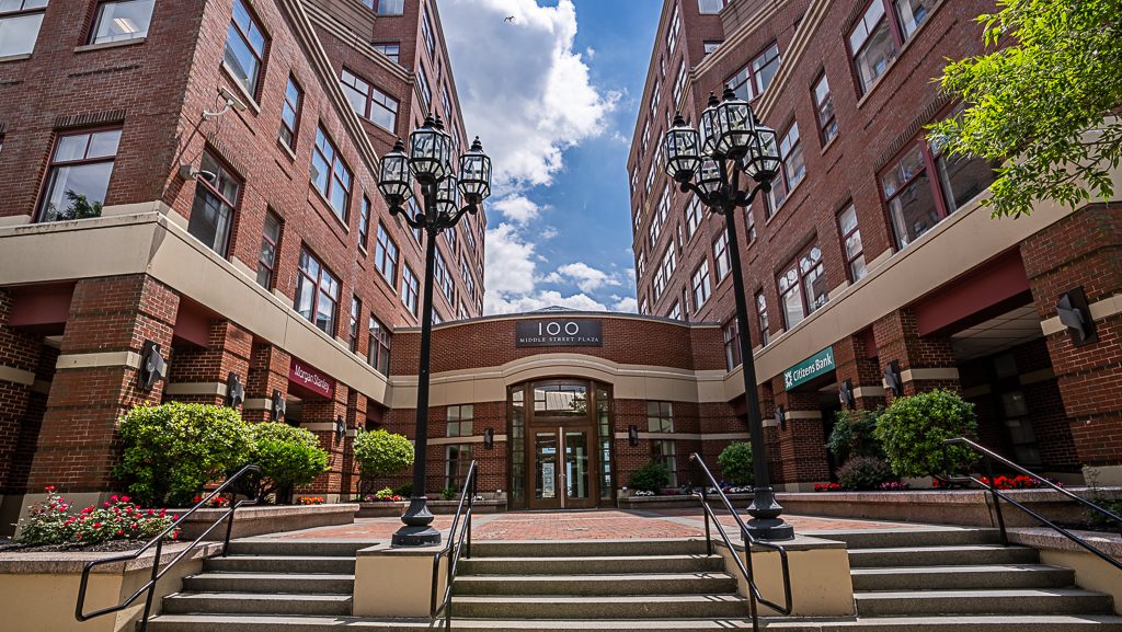 Two building sections are connected by a courtyard.