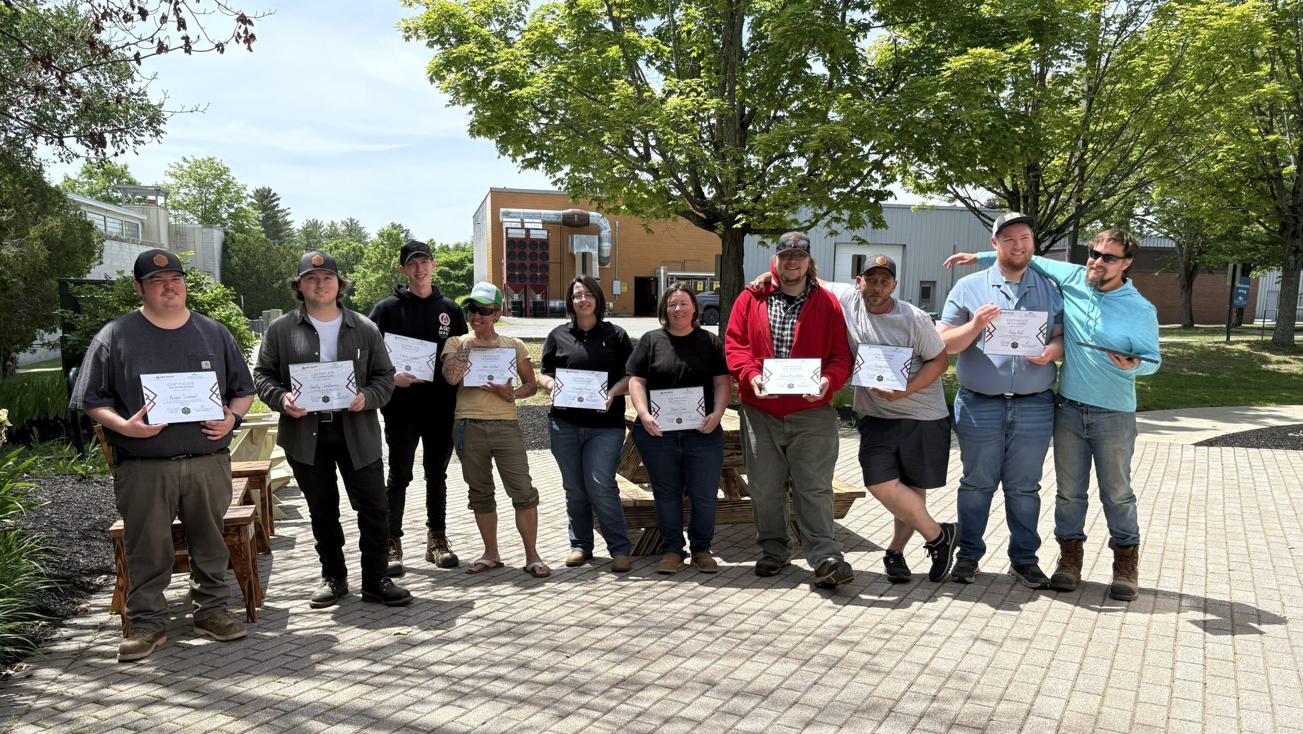 A group of people pose outside.