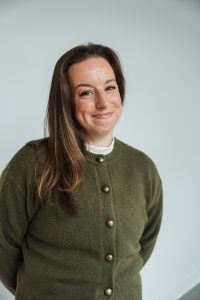 A person wears a button-down sweater.