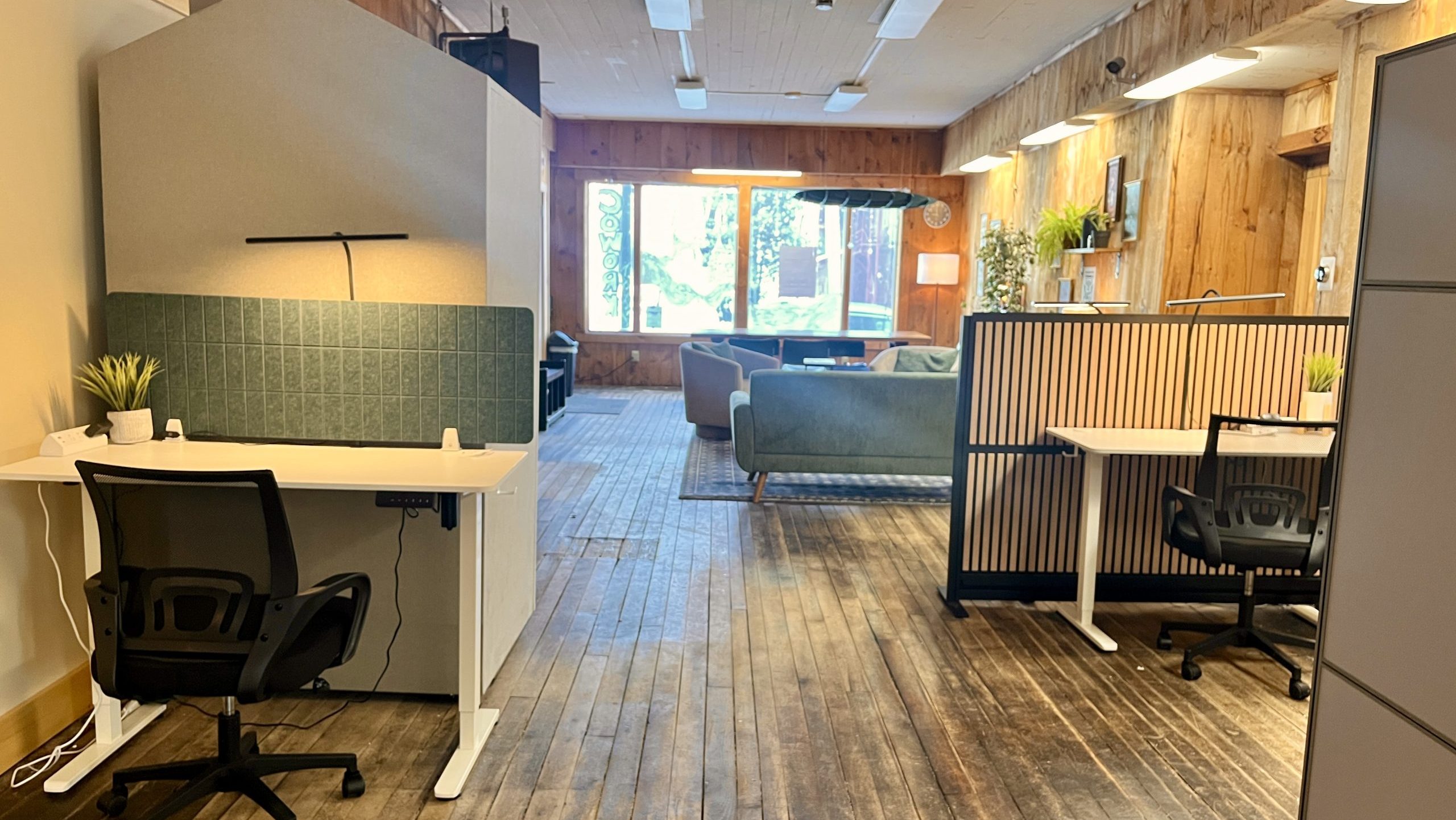 A room has wooden floors and desks.