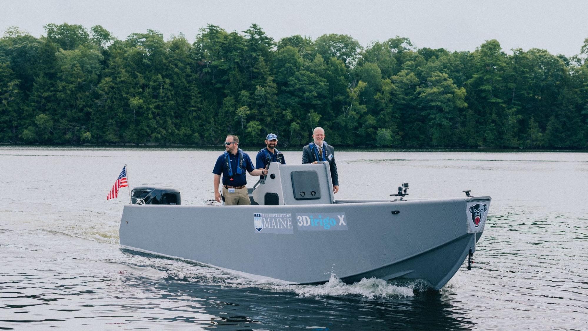 Three people stand on a boat.