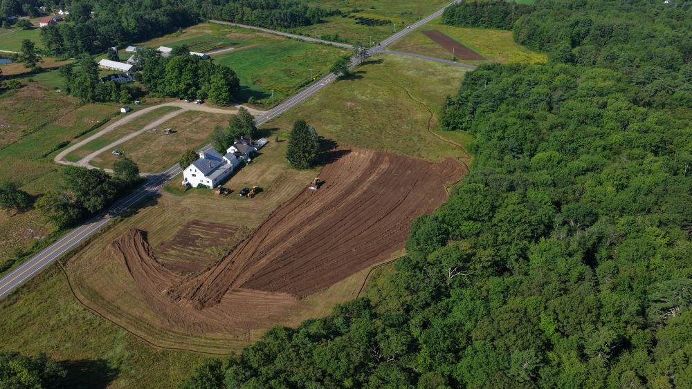 An aerial view of a farm and house.