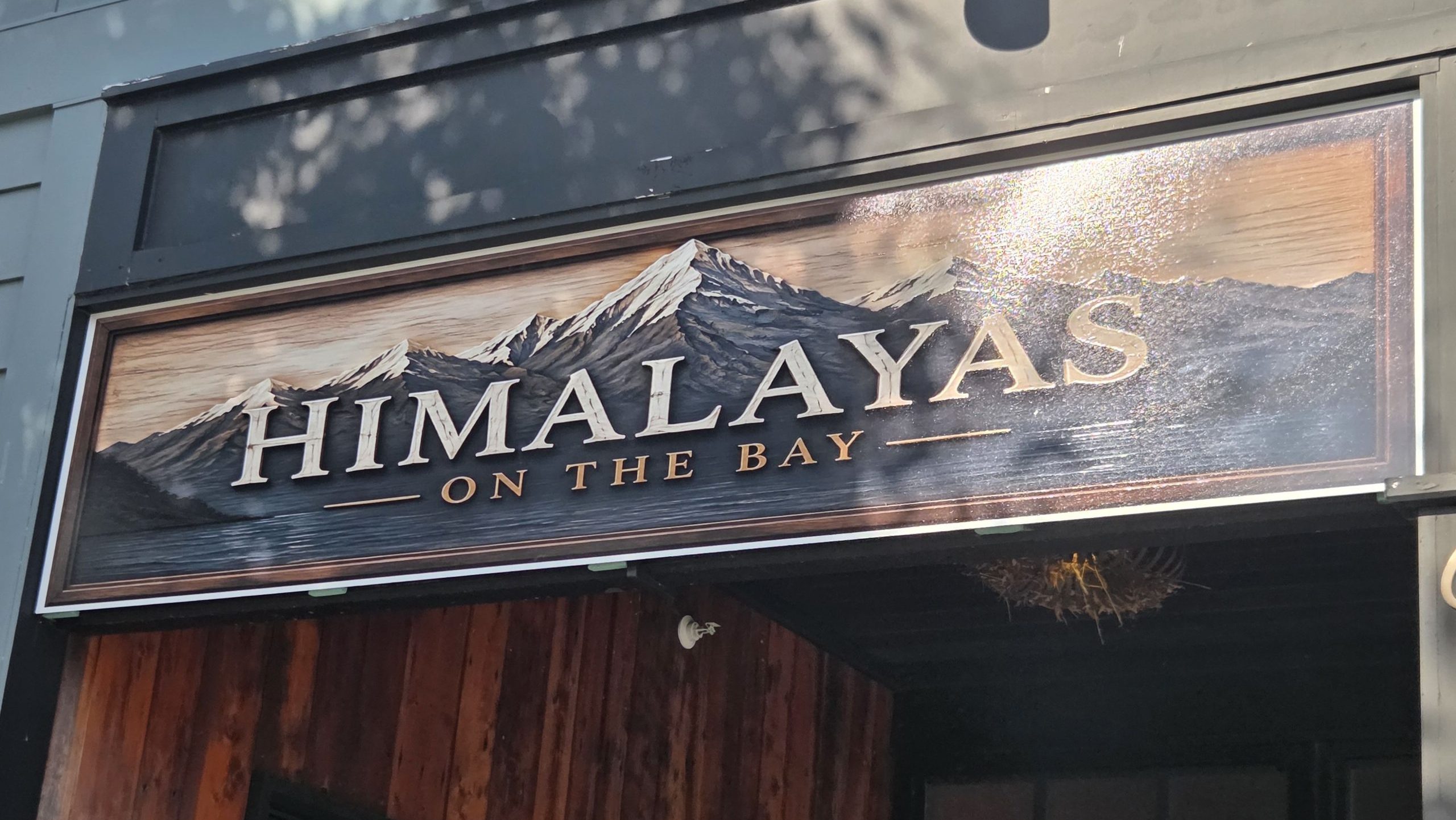 The exterior of a building has a sign.